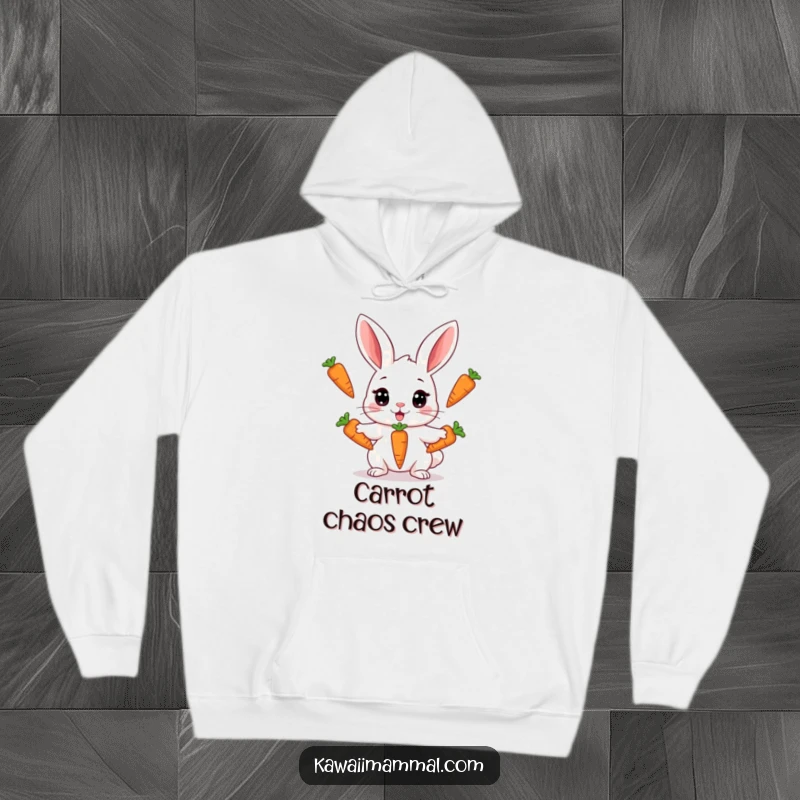 Funny, warm hoodie depicting a Kawaii rabbit concentrating hard while juggling three carrots, offering cozy comfort and humorous charm.