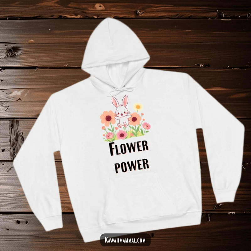 Funny hoodie with a kawaii bunny hopping through giant flowers, offering cozy comfort and enchanting floral vibes.